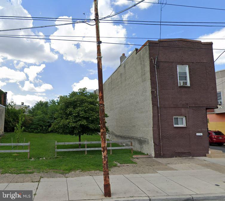 a brick building with a view of a yard