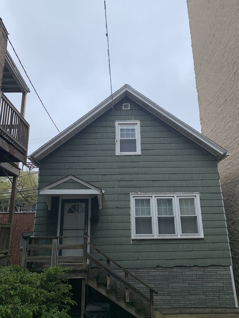 a front view of a house with wooden fence