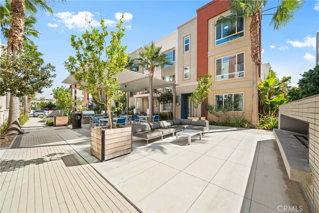 a view of a patio with couches and table and chairs with wooden floor