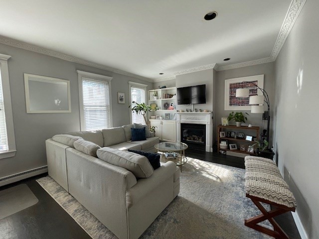 a living room with furniture a flat screen tv and a fireplace