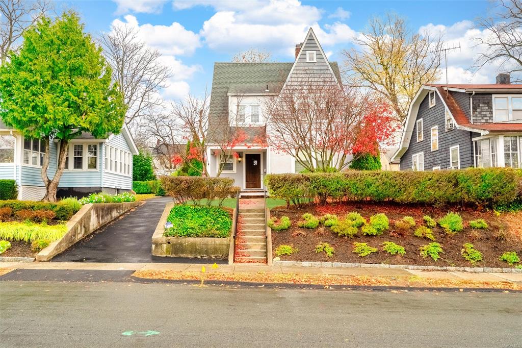 a front view of a house with garden