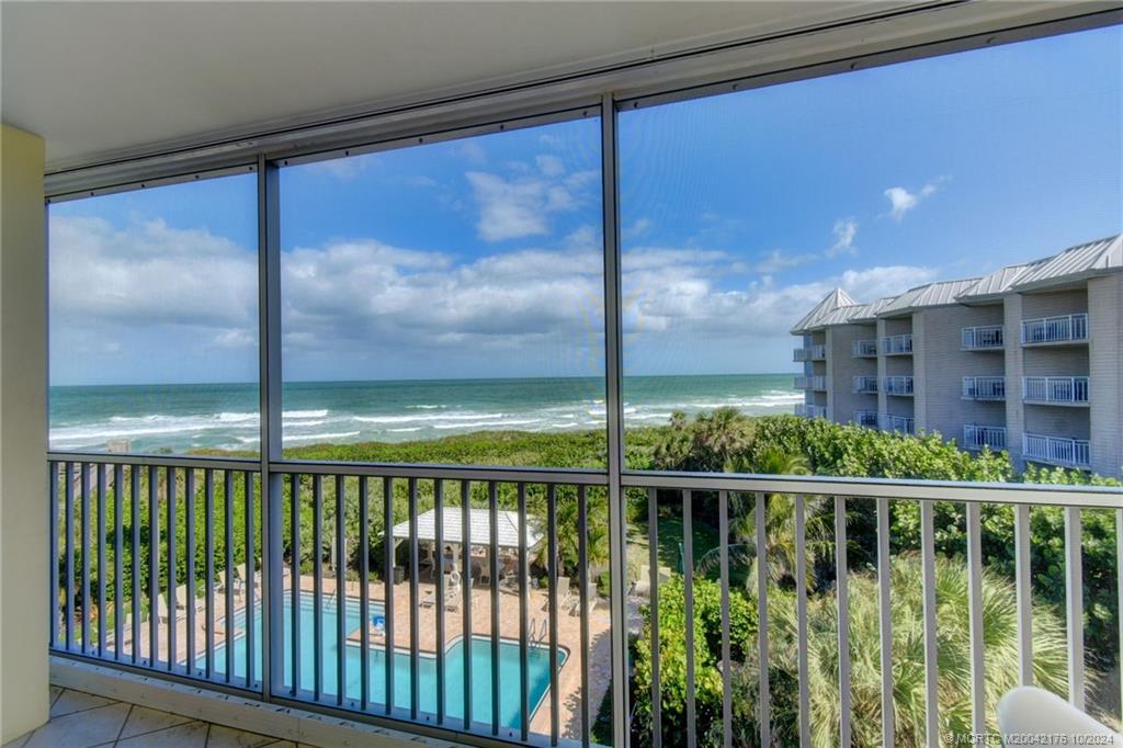 a view of a glass door and a balcony