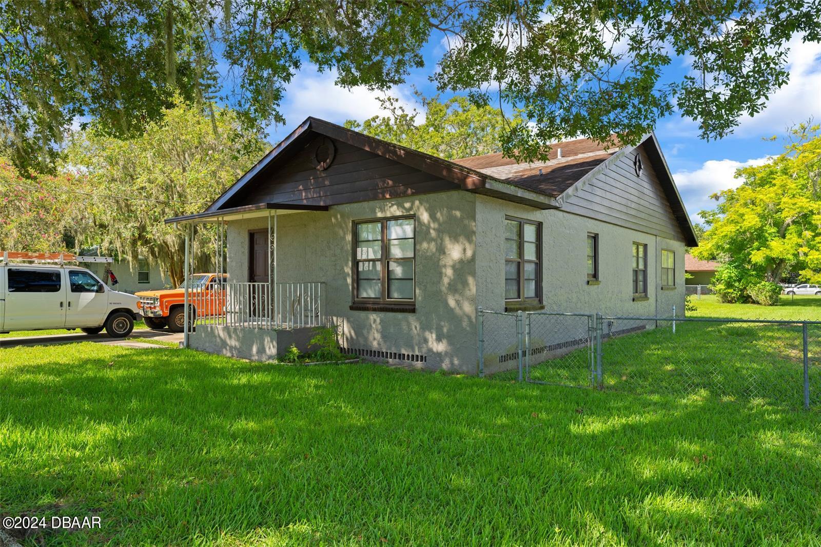 a front view of house with yard and green space