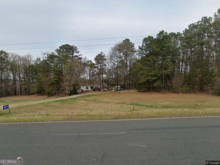 a view of a yard with a large tree