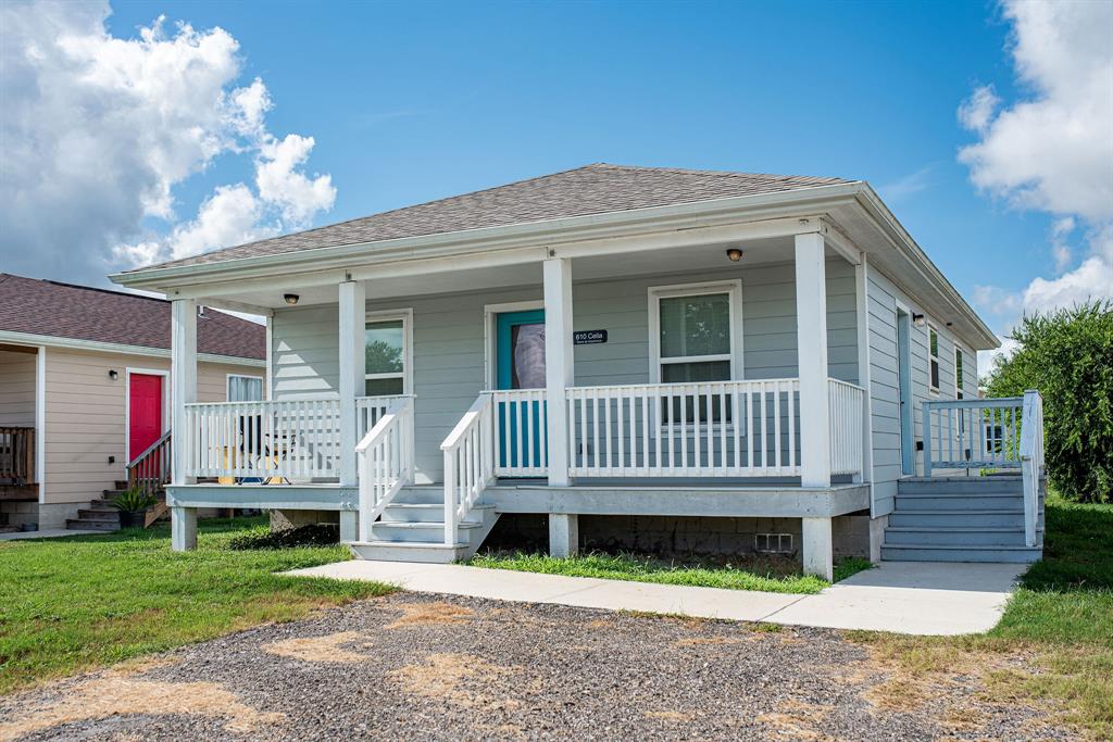 a view of a house with a yard and a porch