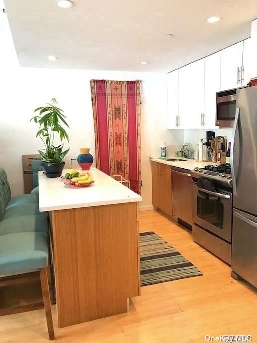 a kitchen with stainless steel appliances a stove a refrigerator and a sink