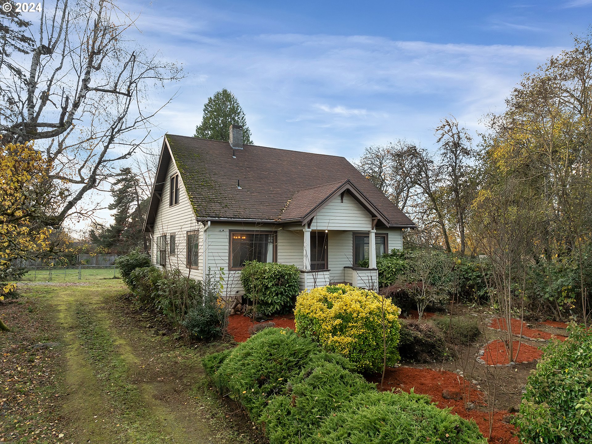 a view of a house with a yard and potted plants