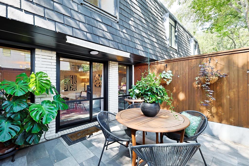 a outdoor dining space with furniture and potted plants