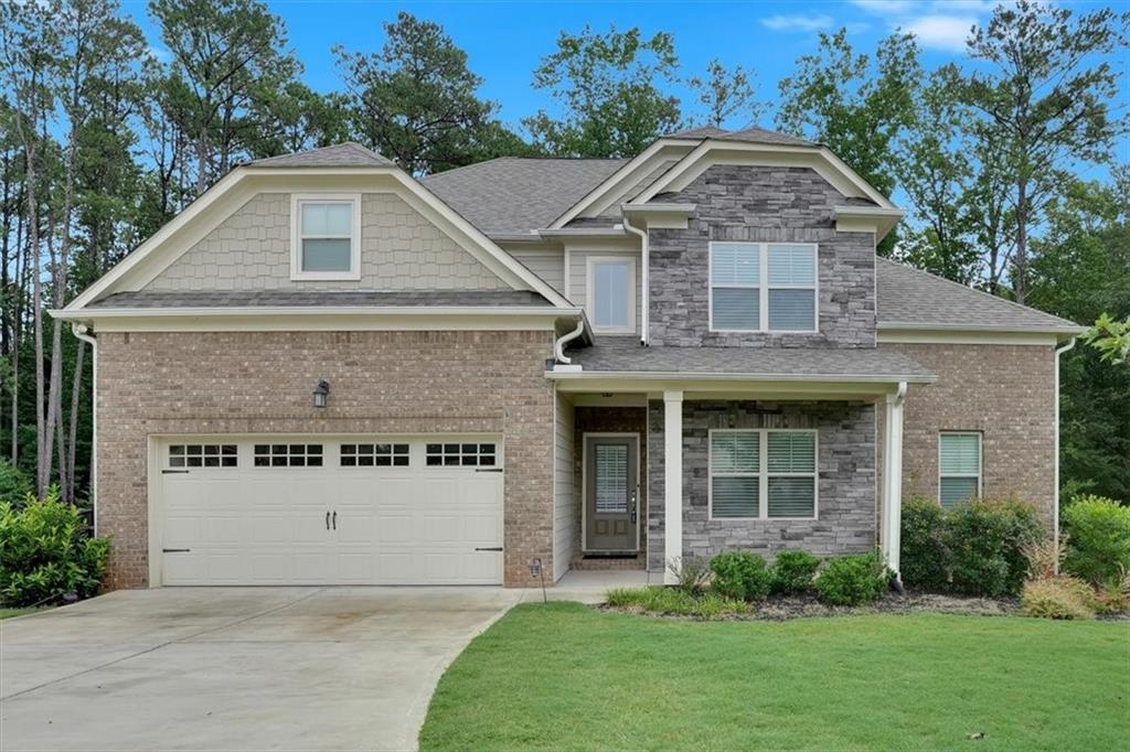 a front view of a house with a yard