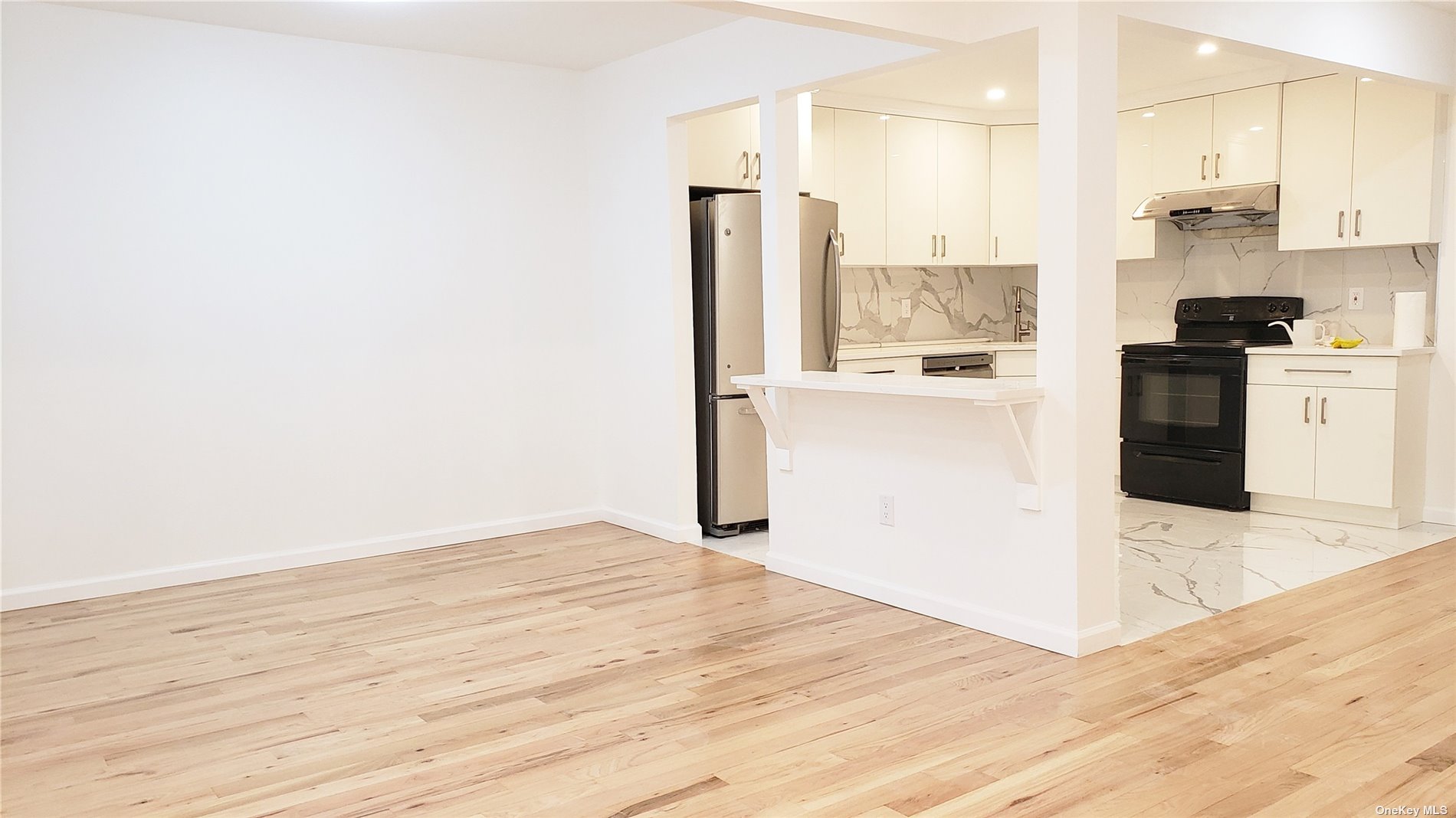 a view of a kitchen with wooden floor