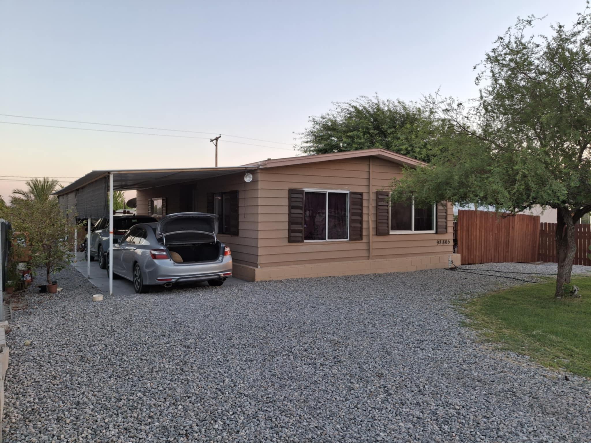 a view of a house with backyard and barbeque area