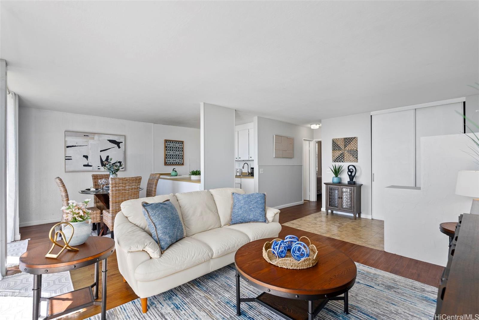 a living room with furniture a rug and a table