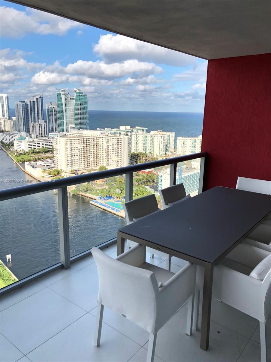 a view of a chairs and table in the balcony