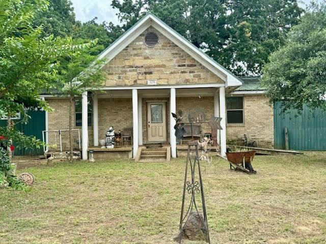 a view of a house with backyard porch and sitting area