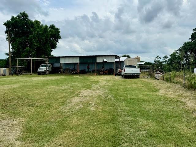 a view of a house with yard and sitting area