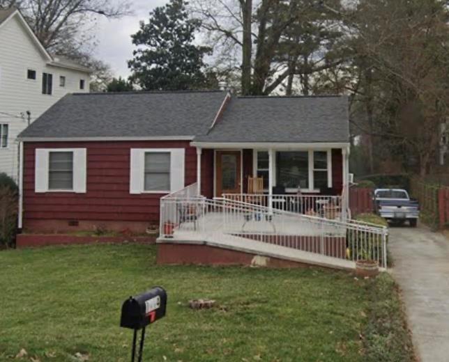 a front view of house with a garden and patio