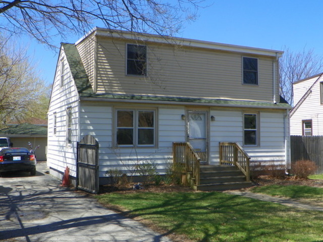 a front view of house with a garden