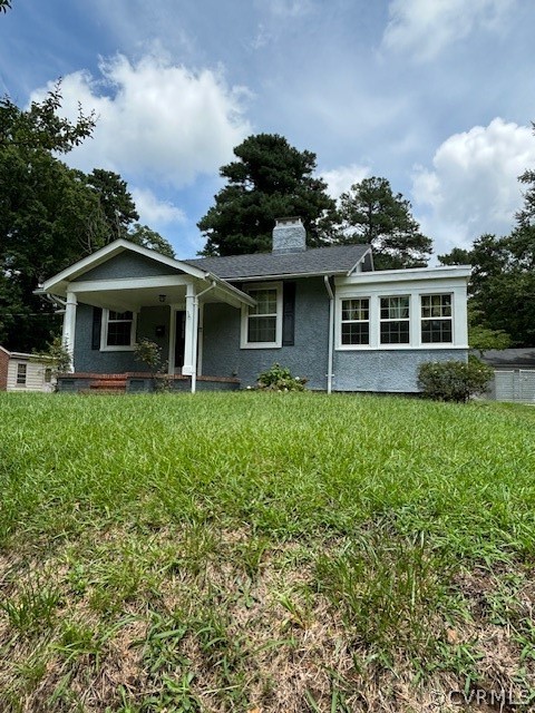 a front view of a house with a yard and potted plants