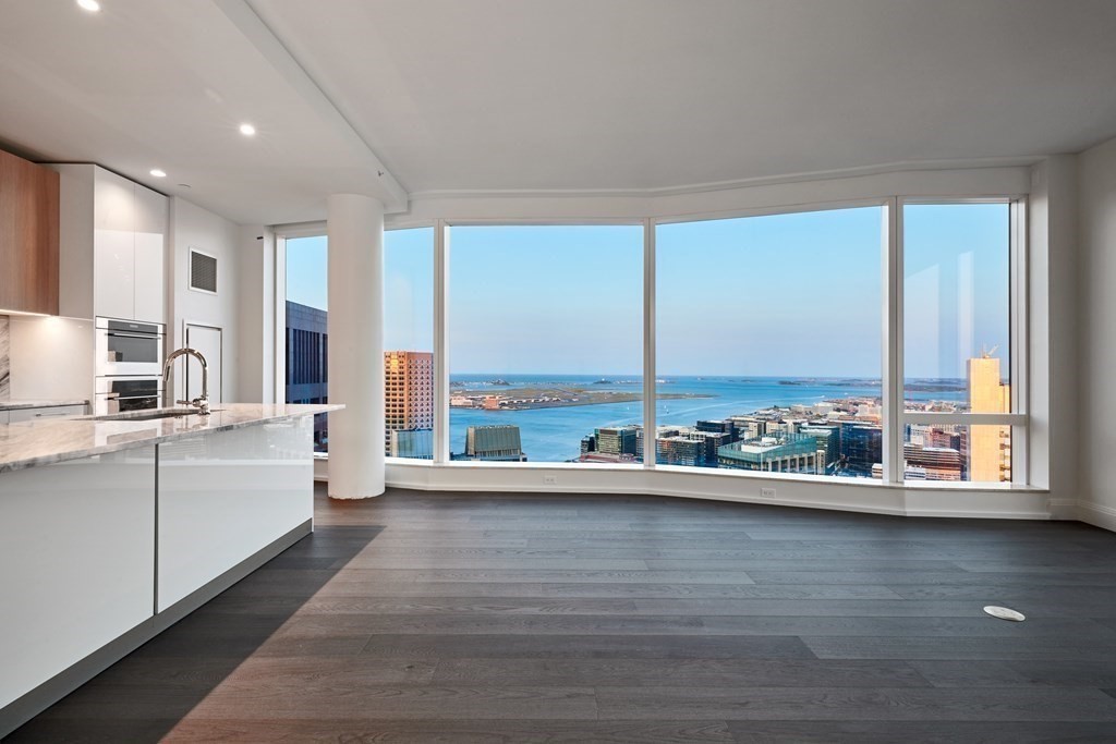 a large white kitchen with a large window