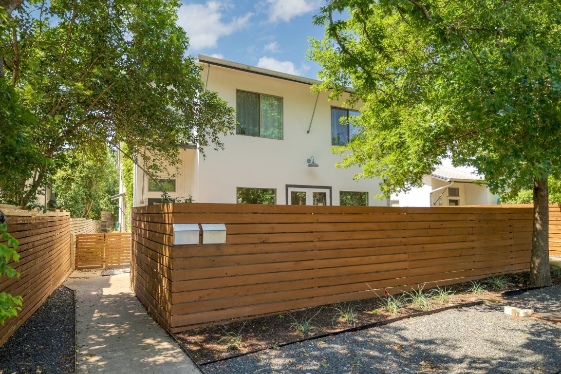 a view of a wooden house with a tree