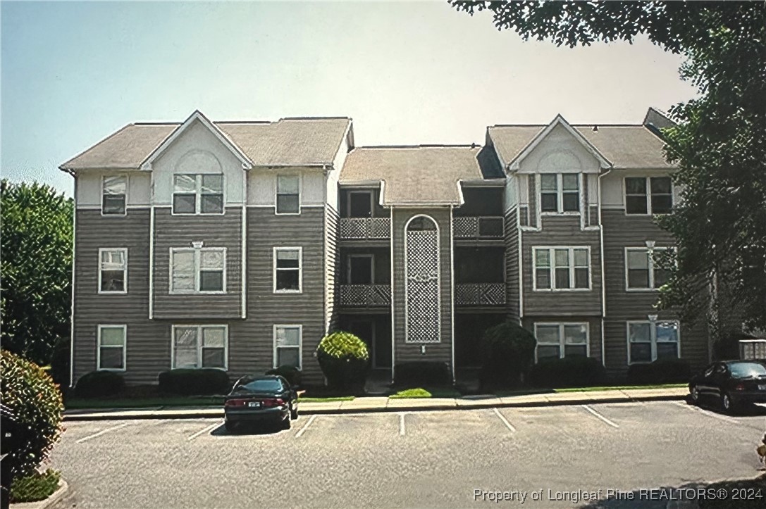 a view of a brick house with many windows