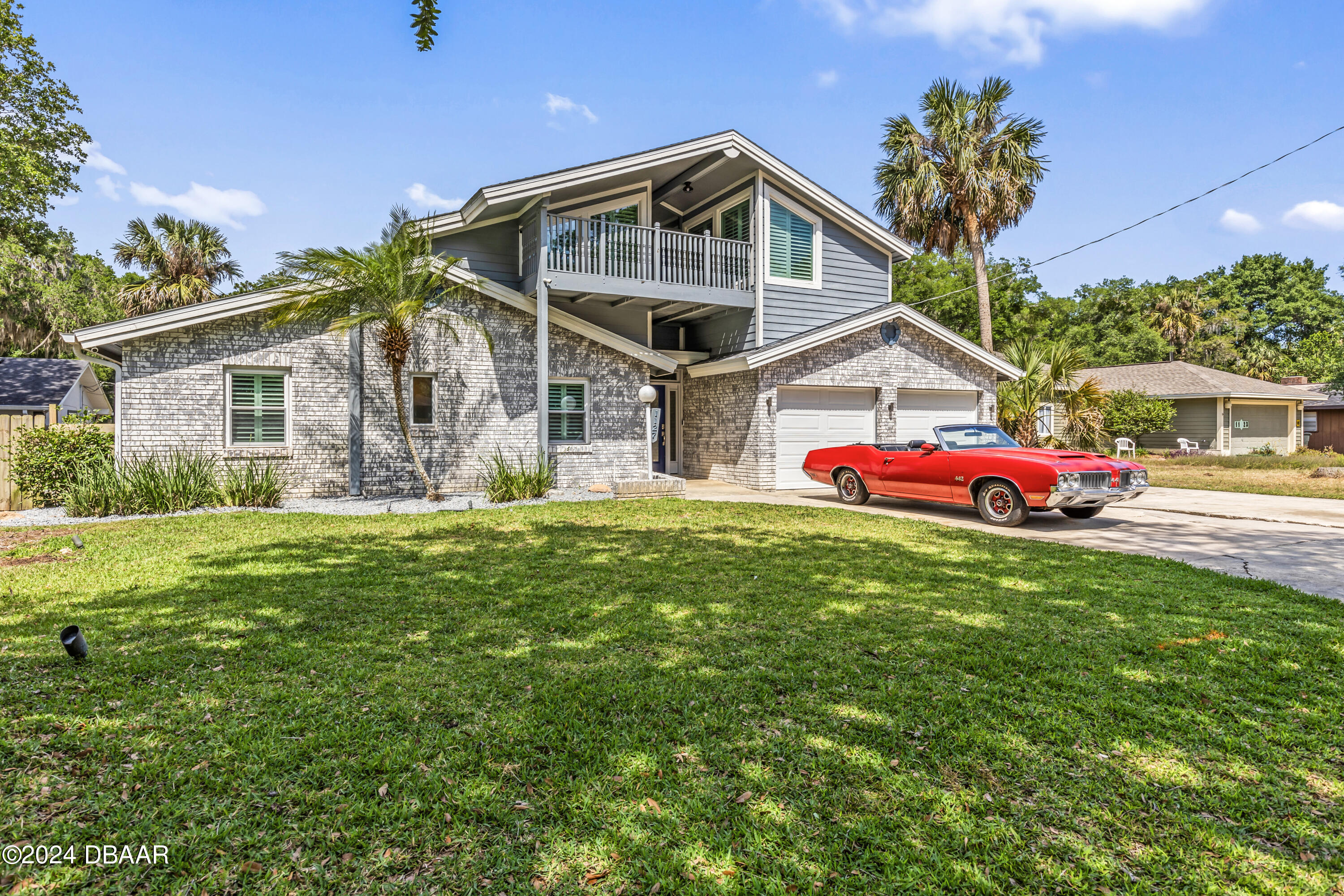 a front view of house with yard and green space