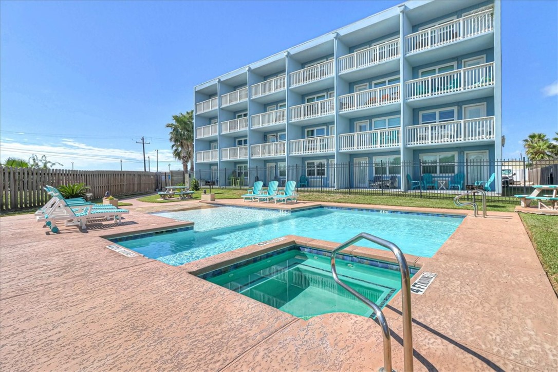 a view of pool with outdoor seating and yard