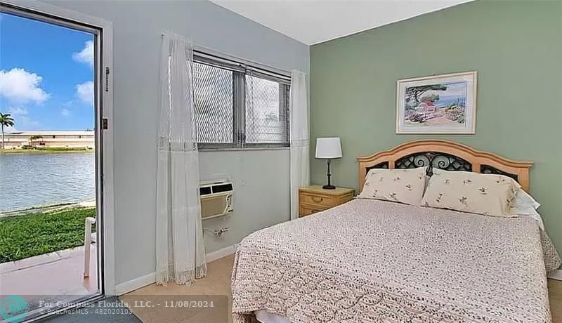 a bedroom with a bed and a view of balcony