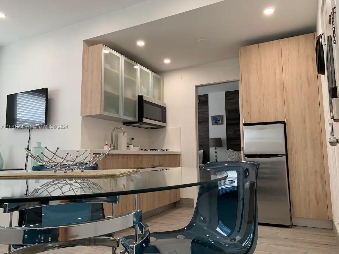 a kitchen with a sink appliances and cabinets