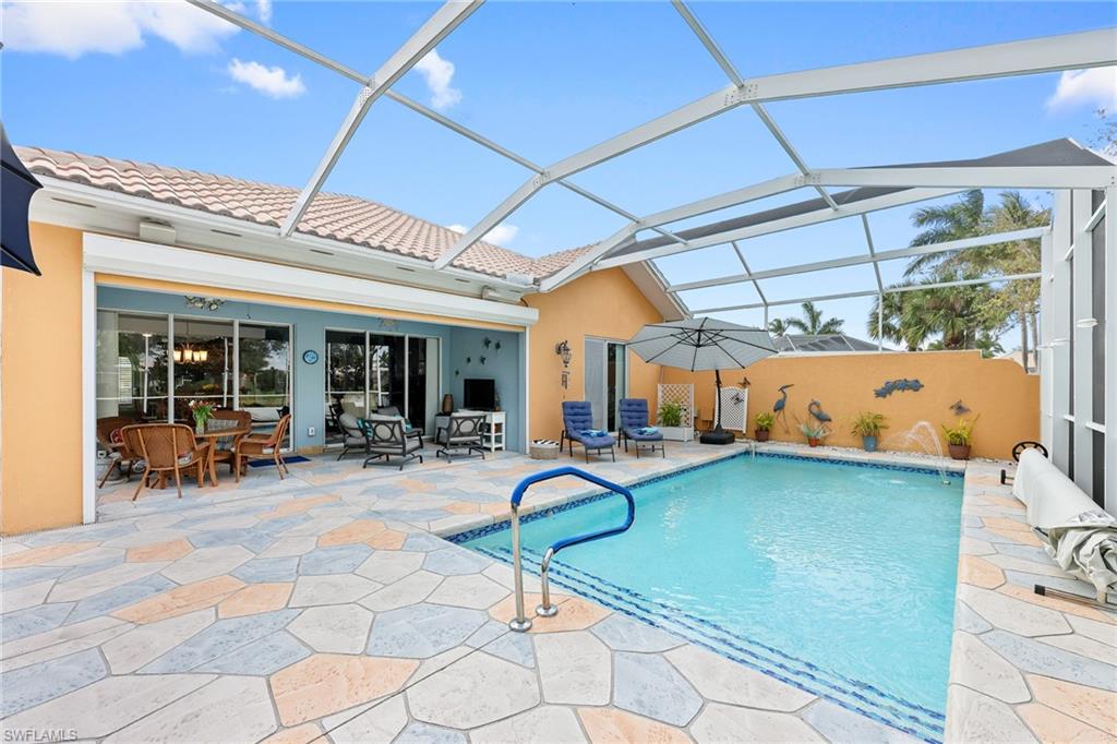 a swimming pool with outdoor seating and yard