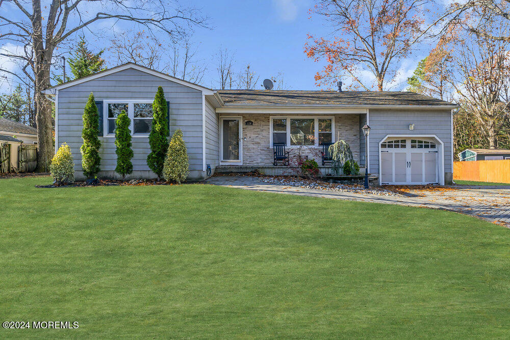 a front view of a house with garden and porch