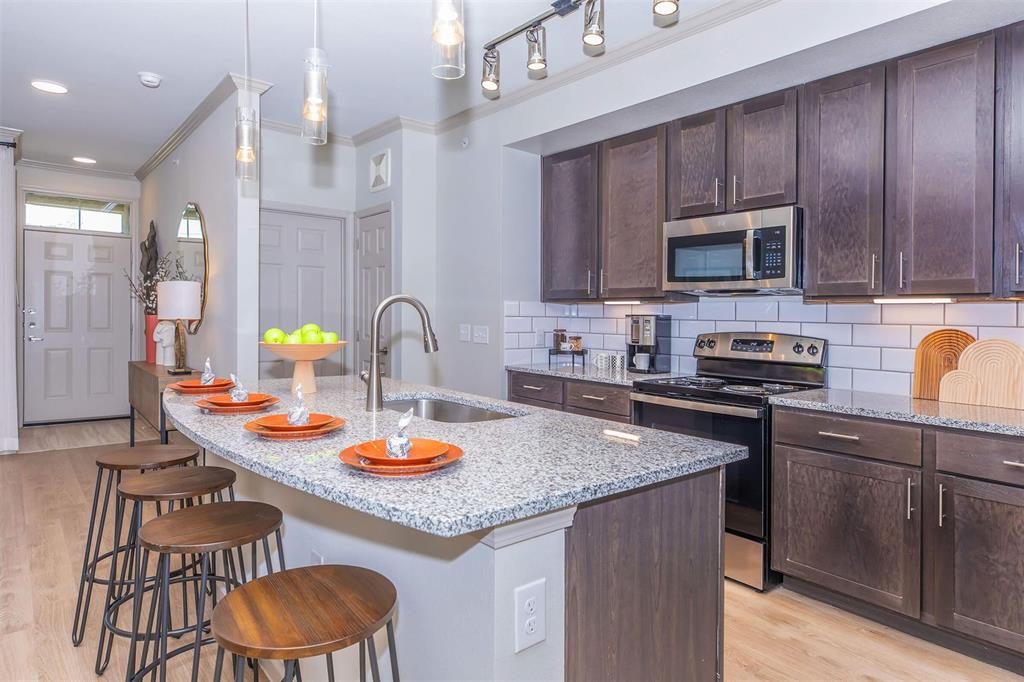 a kitchen with a sink stove and cabinets