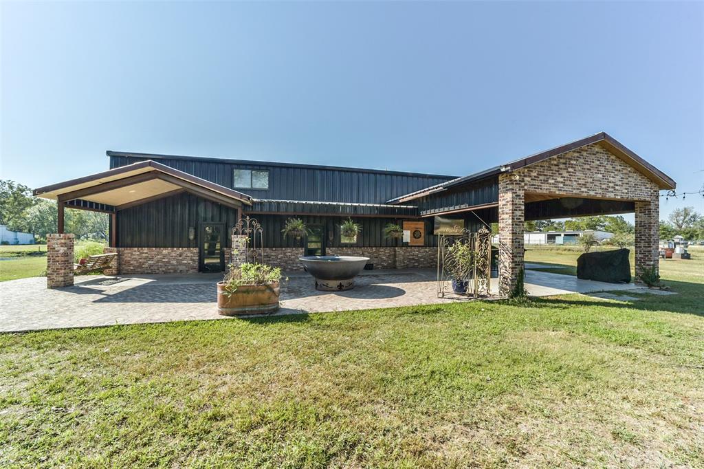 a view of a house with backyard porch and sitting area