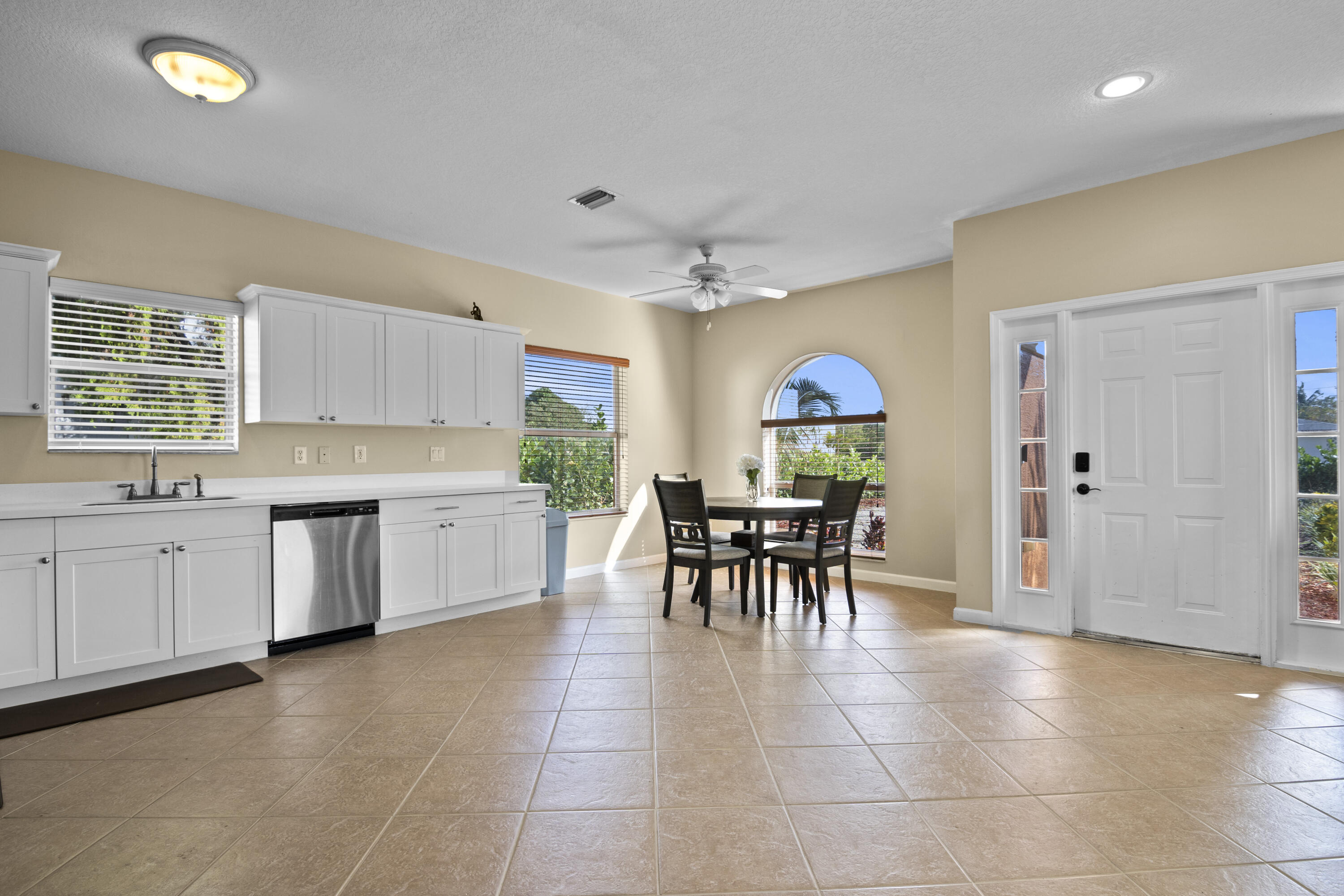 a kitchen with granite countertop cabinets a table and chairs in it