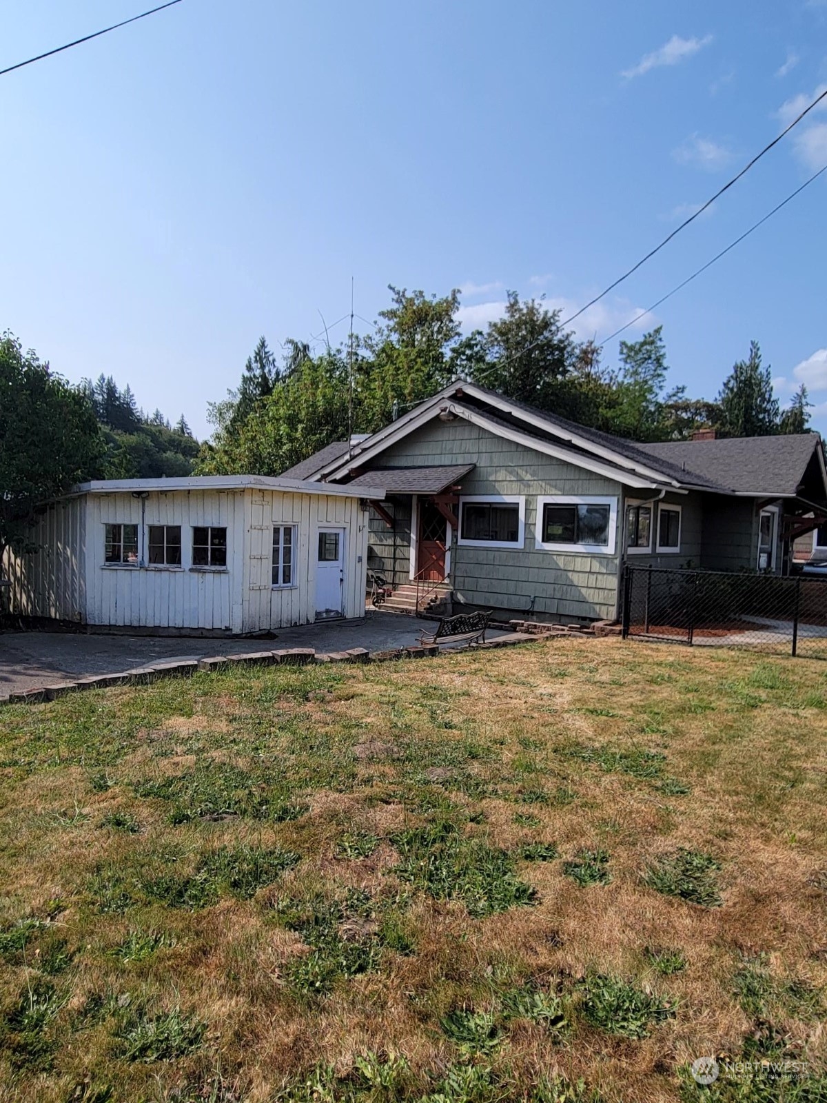 a front view of a house with a garden