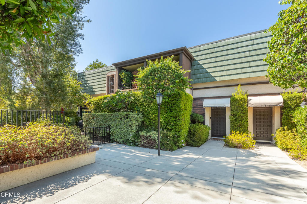 a view of a house with a yard and plants