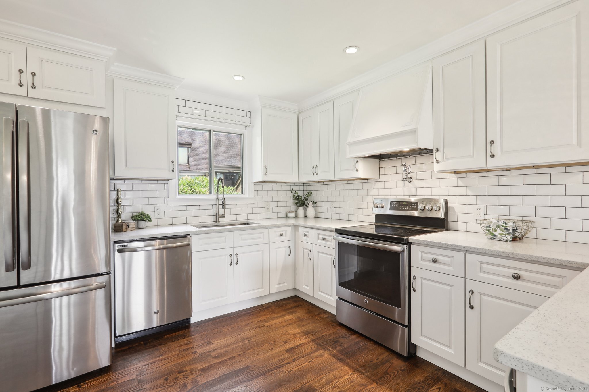 a kitchen with a white cabinets and white stainless steel appliances