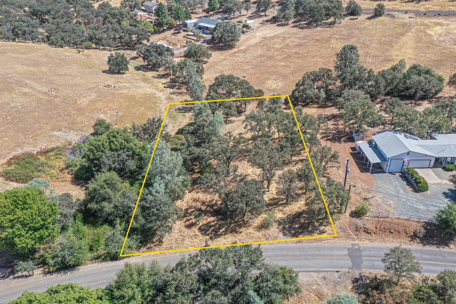 an aerial view of a houses on a road