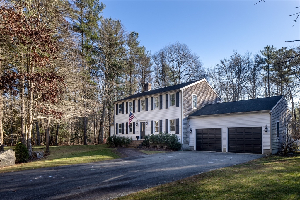 a front view of a house with yard and green space