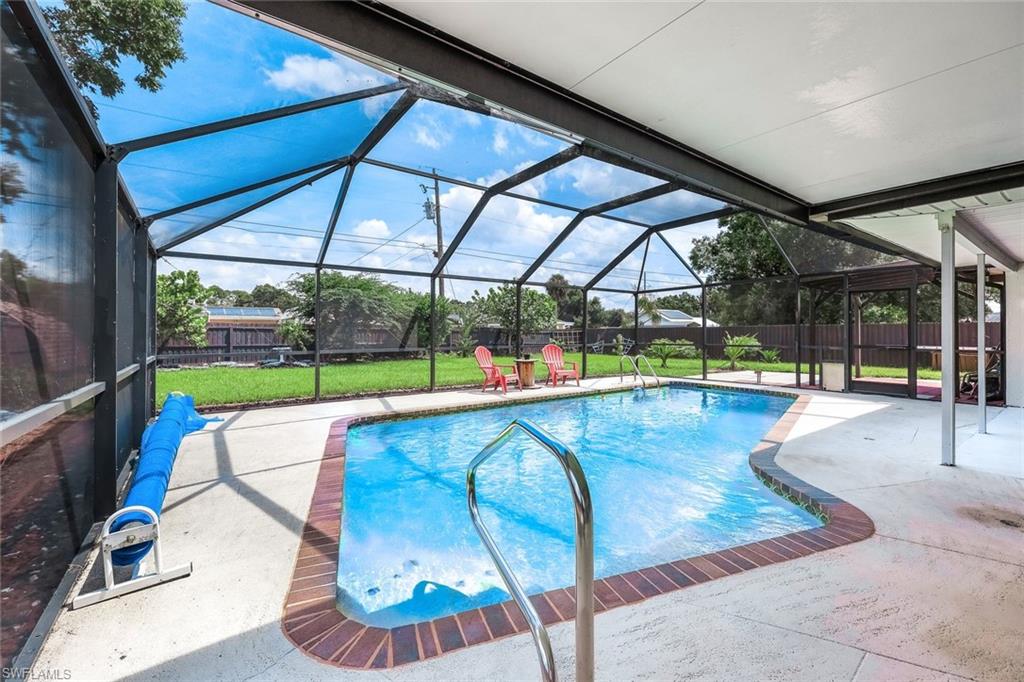 View of pool with a yard, a lanai, and a patio area