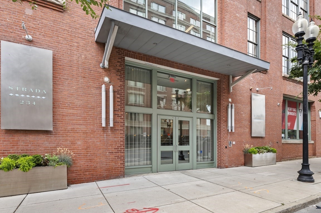 a view of a brick building with a bench in front of building