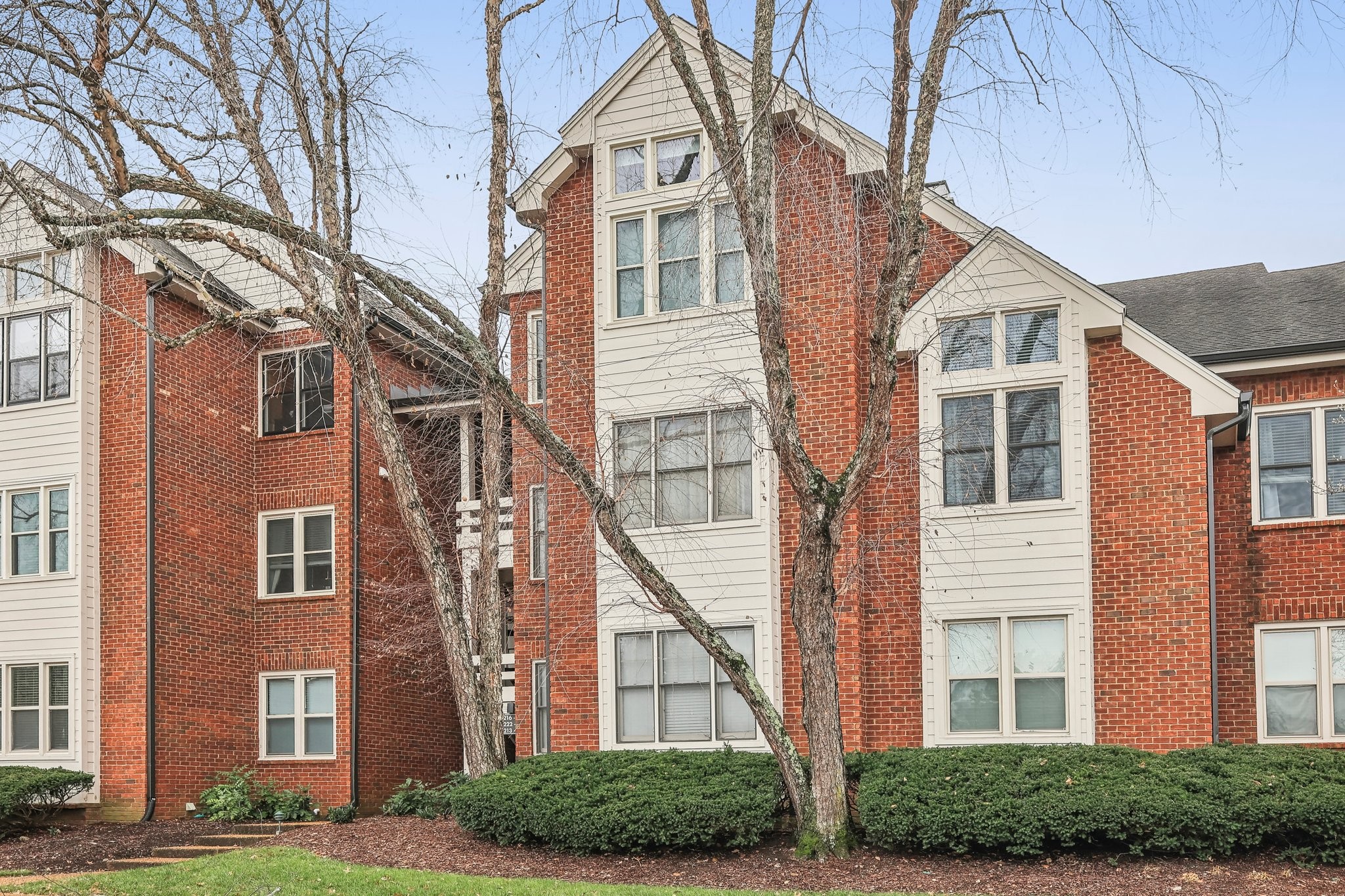 a view of a brick building next to a yard