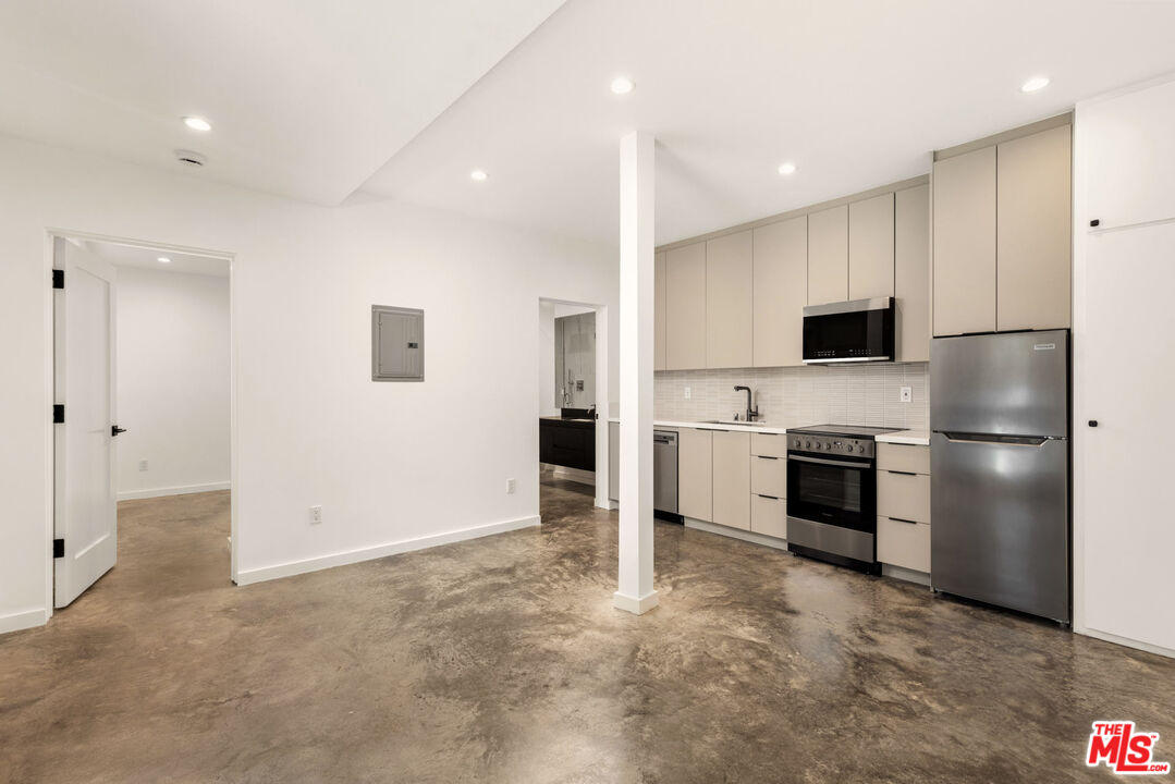 a kitchen with a sink stainless steel appliances and cabinets