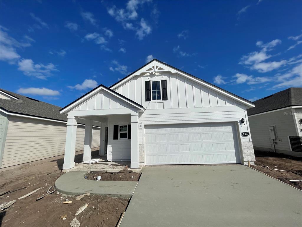 a front view of a house with yard garage and garage