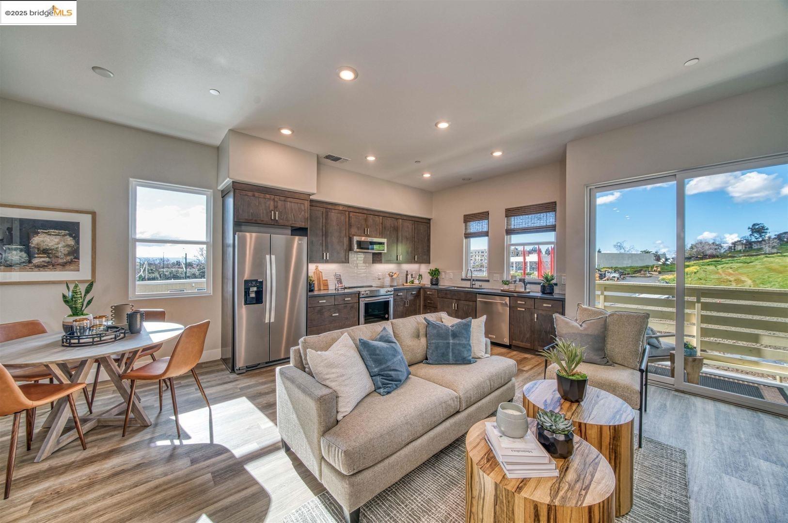 a living room with furniture and kitchen view