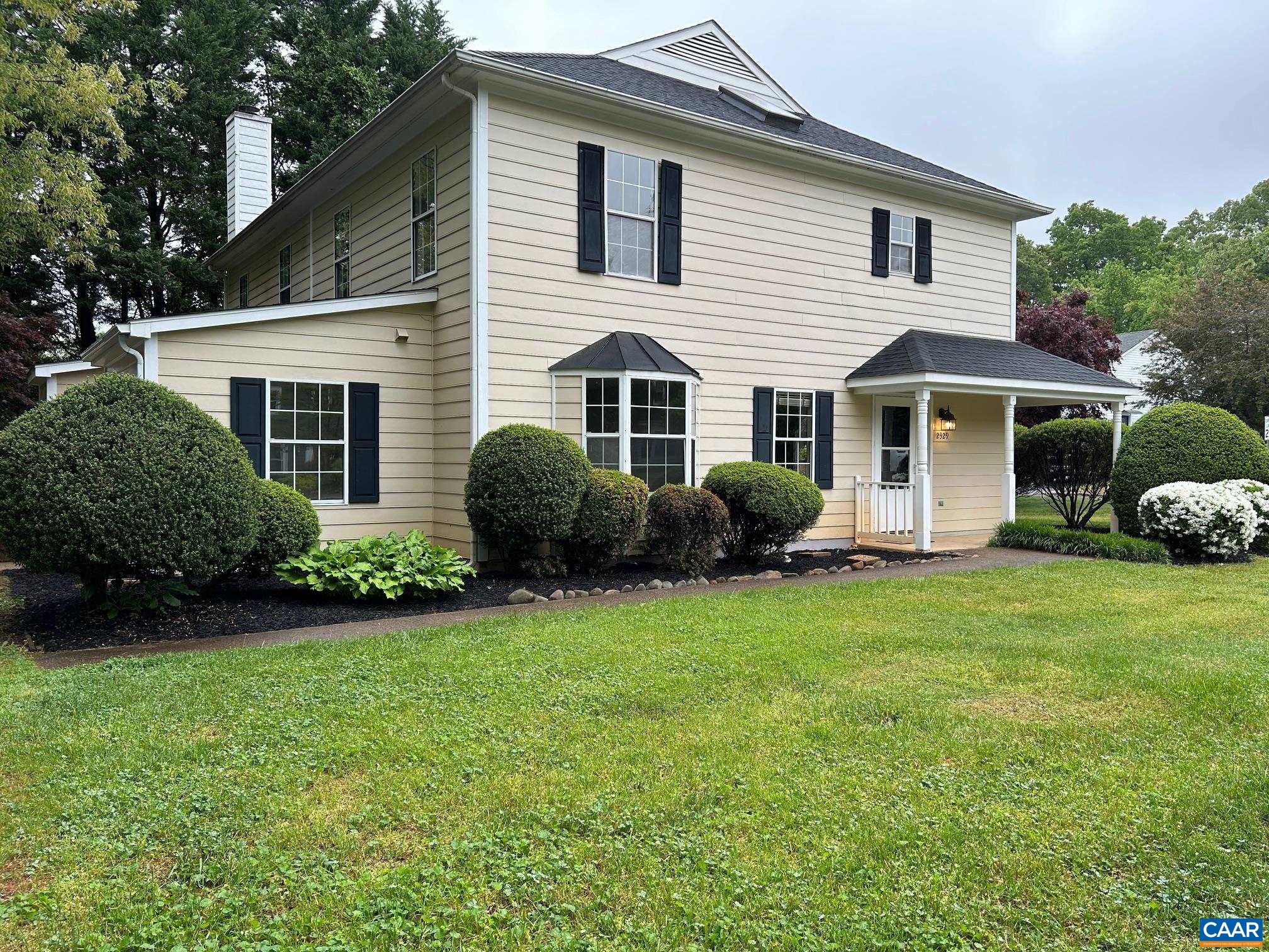 a view of a house with a backyard