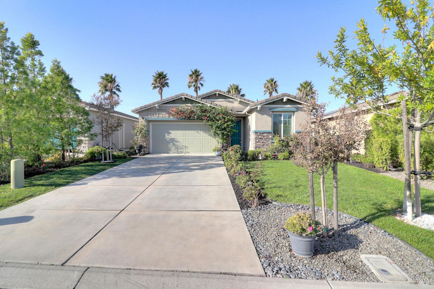 a view of a house with a yard and a fountain