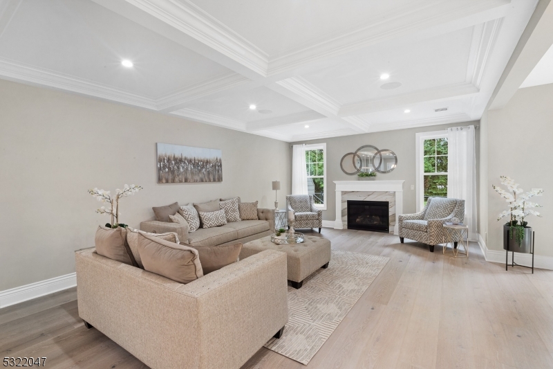 a living room with furniture a fireplace and a large window