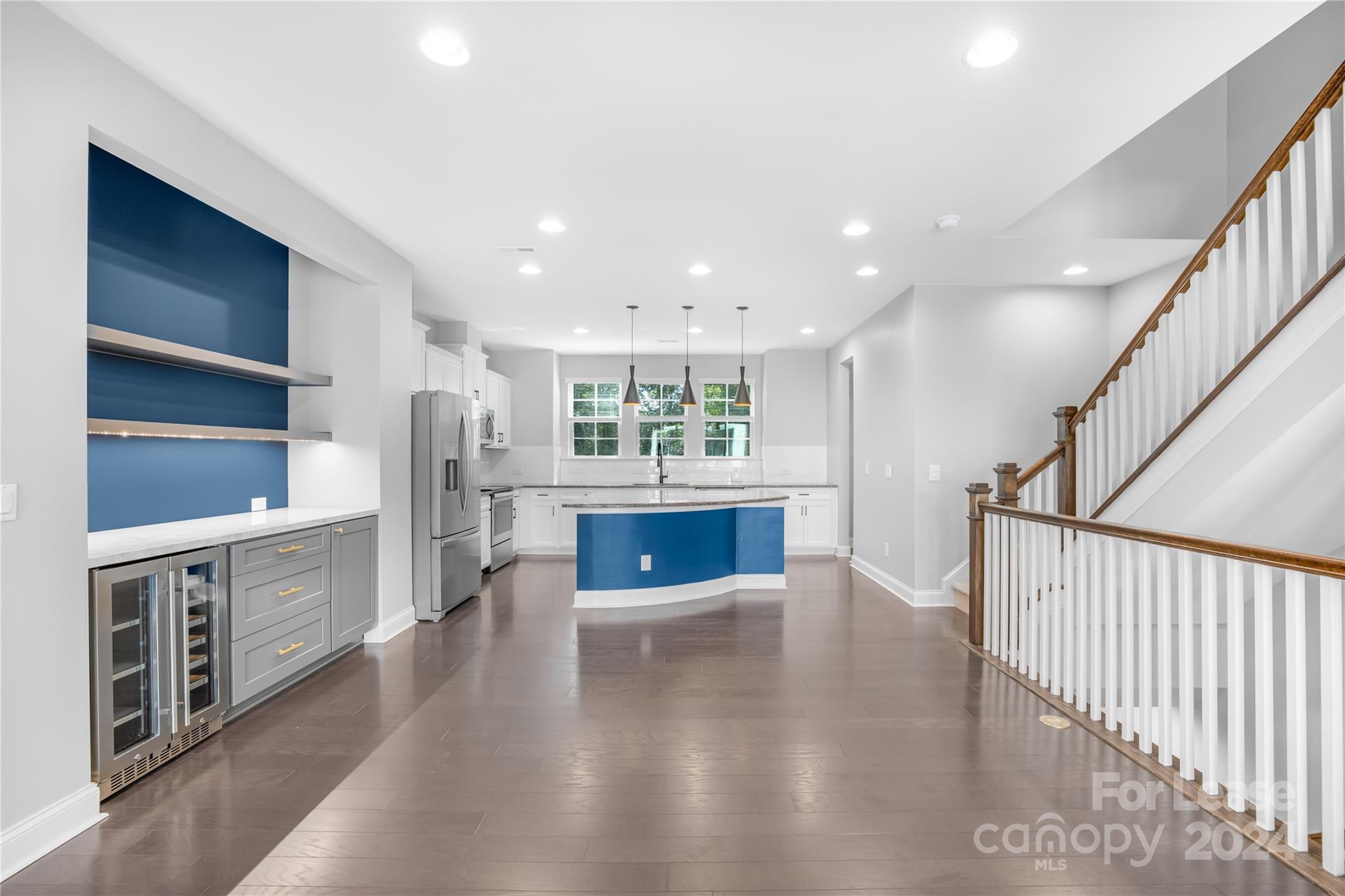 a view of a kitchen with cabinets and wooden floor