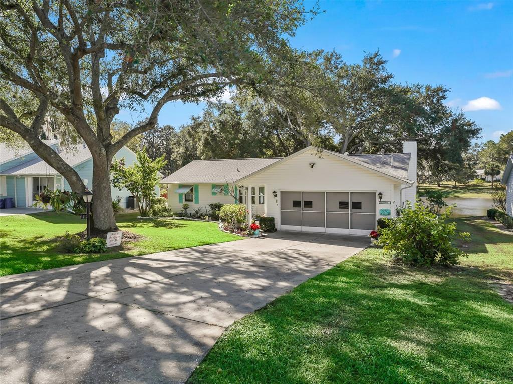 FRONT VIEW WITH LONG DRIVEWAY